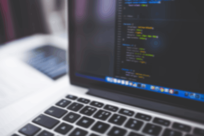 Blurred image of laptop monitor with code on it