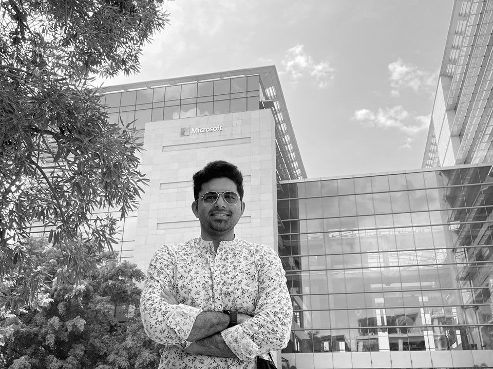 Person standing in front of Microsoft building